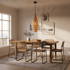 Woven rattan pendant light hanging above a wooden dining table with six chairs, creating a cozy atmosphere.