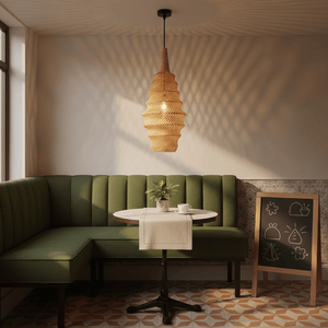 Ocean Rattan Pendant 310 hanging above a round table in a cozy green booth, casting soft shadows.