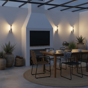 Stylish outdoor setting featuring stainless steel wall lights illuminating a dining area with a table and chairs.
