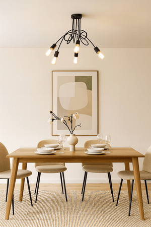 Dining room with wooden table, chairs, and modern chandelier.
