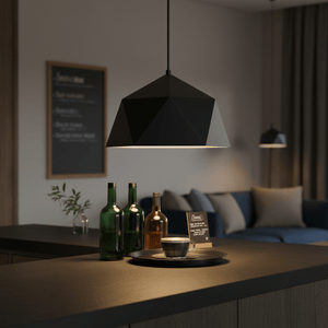 Black metal pendant light illuminating a coffee cup on a dark countertop, with bottles in the background.