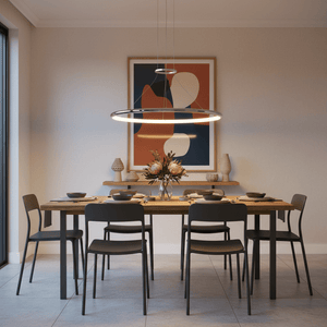 Anelli 1 Chrome LED Ring Pendant hanging above a wooden dining table set with plates and flowers.