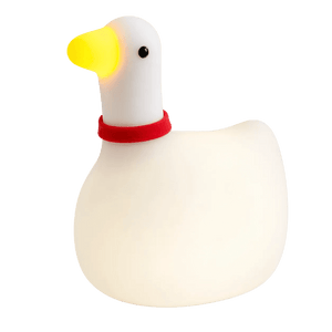 A white, rounded goose-shaped night light with a yellow beak, black eyes, and a red collar.
