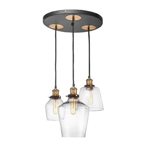 Three-light cluster pendant with glass shades, antique brass fittings, black cords hanging from a ceiling canopy