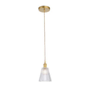 Pendant light with glass shade and gold fixture on a black background