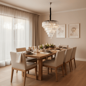 Layered crystal chandelier with black cord and chrome frame hanging centrally over a set wooden table