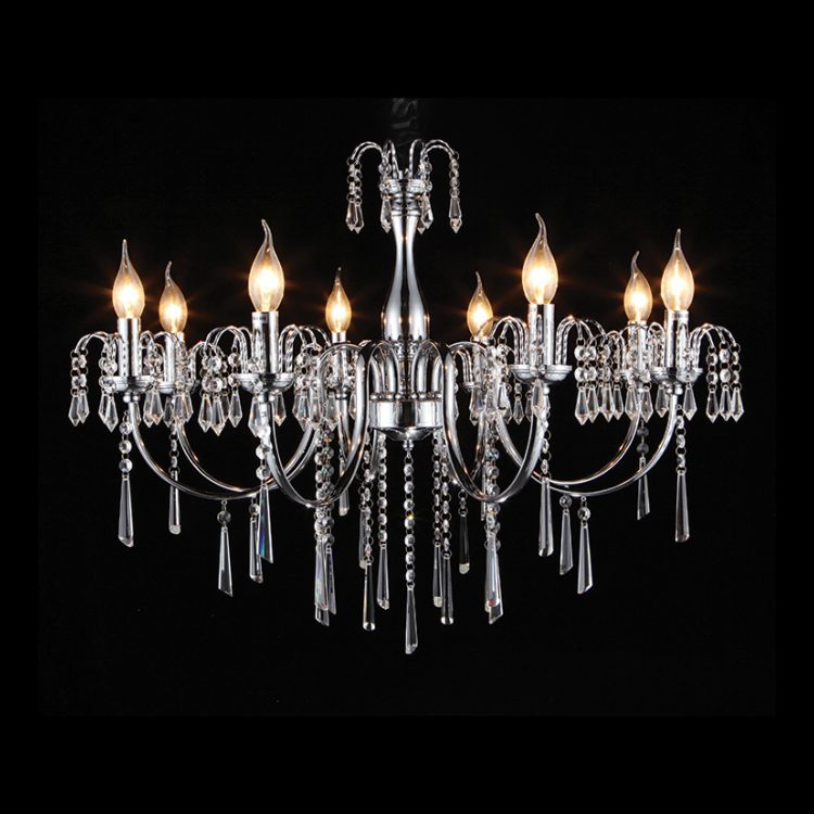 Eight-light chrome and crystal chandelier with illuminated bulbs against black background