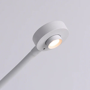 Close-up view of the Camera LED Desk Lamp's white base and light, showcasing the sleek design and warm light output.