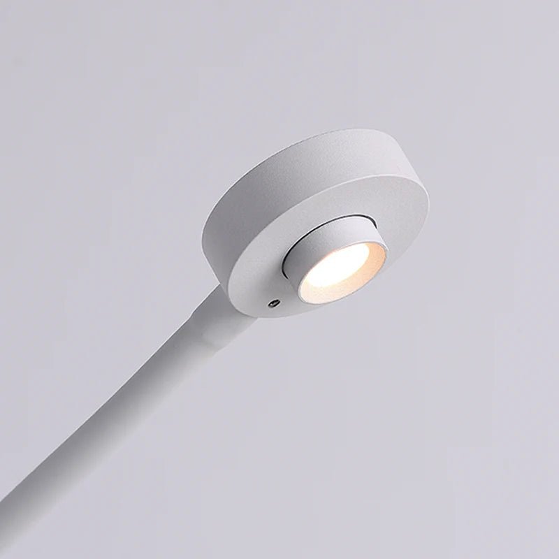 Close-up view of the Camera LED Desk Lamp's white base and light, showcasing the sleek design and warm light output.