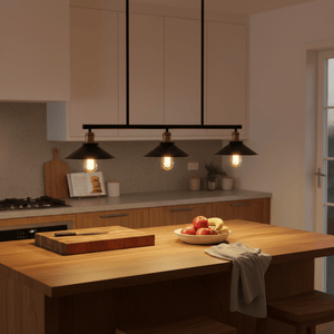 Haley Trio Black & Brass Pendant Light illuminating a kitchen island with fresh fruit and wooden accents.