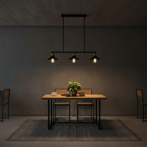 Haley Trio Black & Brass Pendant Light above a wooden dining table with plants and tableware.