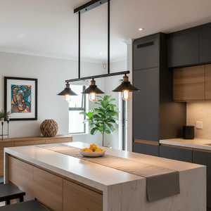 Haley Trio Black & Brass Pendant Light hanging over a kitchen island with a bowl of lemons.