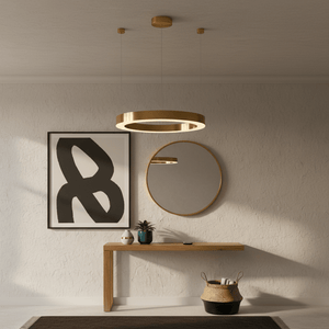 Halo Gold LED Pendant light hanging above a wooden console table with a mirror and artwork in a modern interior.