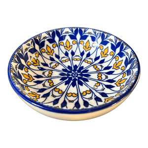 Ceramic flat bowl with blue and yellow mandala, white background