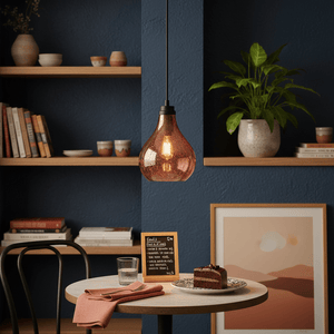 Rose copper glass pendant light hanging above a dining table with a dessert and decor.