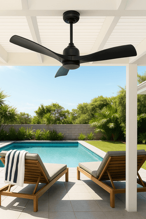 Ceiling fan above two lounge chairs by a pool with a garden view