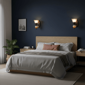Bronze wall sconce with two glass shades on a white background