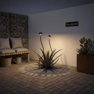 Warm white LED spike lights illuminating a potted plant in a cozy outdoor seating area.
