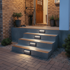 Outdoor stairs illuminated by grey LED foot lights, enhancing safety and style at night.