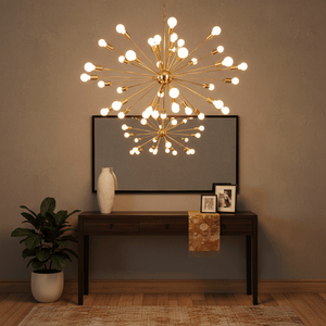 Satin gold pendant light with multiple bulb holders above a wooden console table and decorative items.