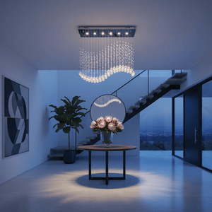 Waverley Chrome Chandelier hanging above a round table with flowers in a modern foyer.