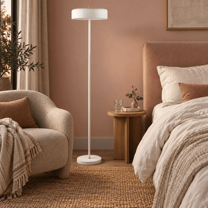 Diaz white floor lamp beside a clay pink bedroom reading chair