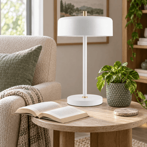 Diaz white table lamp beside a reading chair