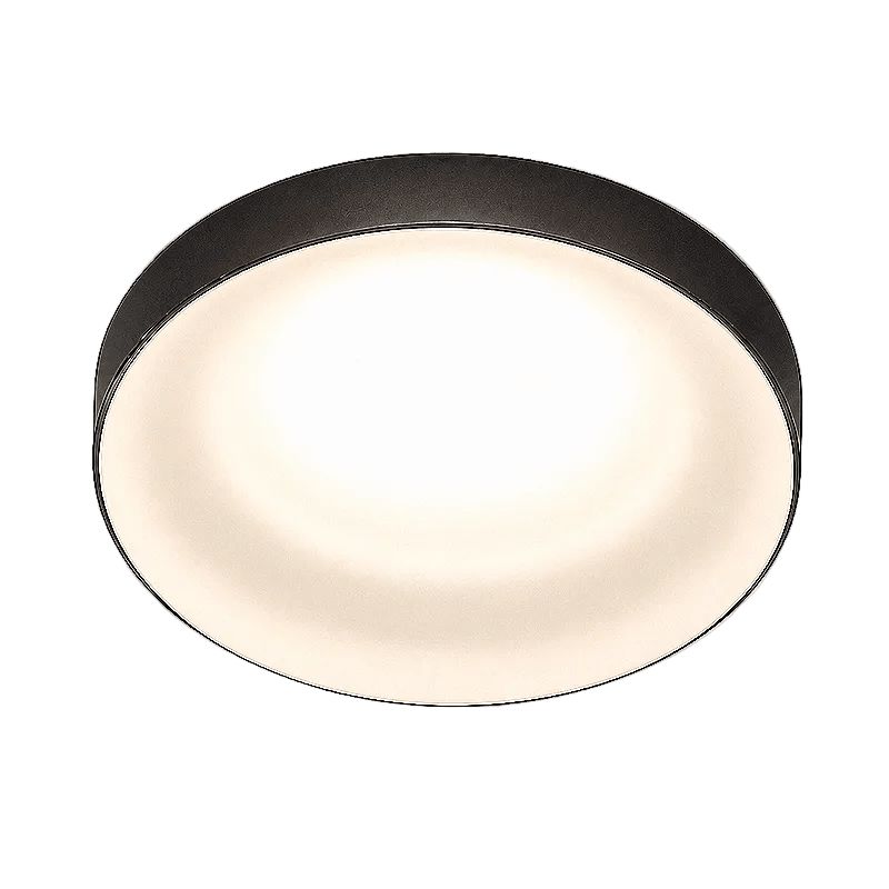 Black round downlight with a softly glowing warm white diffuser