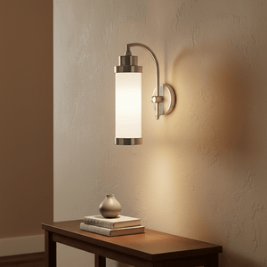 Antique silver Kerala Wall Lamp mounted on a textured wall, illuminating a wooden table with decor.