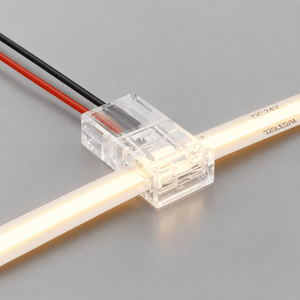 Close-up of an 8mm strip to wire side connector attached to an LED strip, showcasing its clear design and wiring.