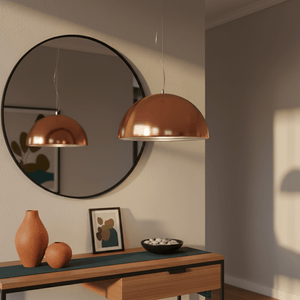 Lucia 400 Copper Pendant light hanging above a wooden console table with decorative vases and a mirror.