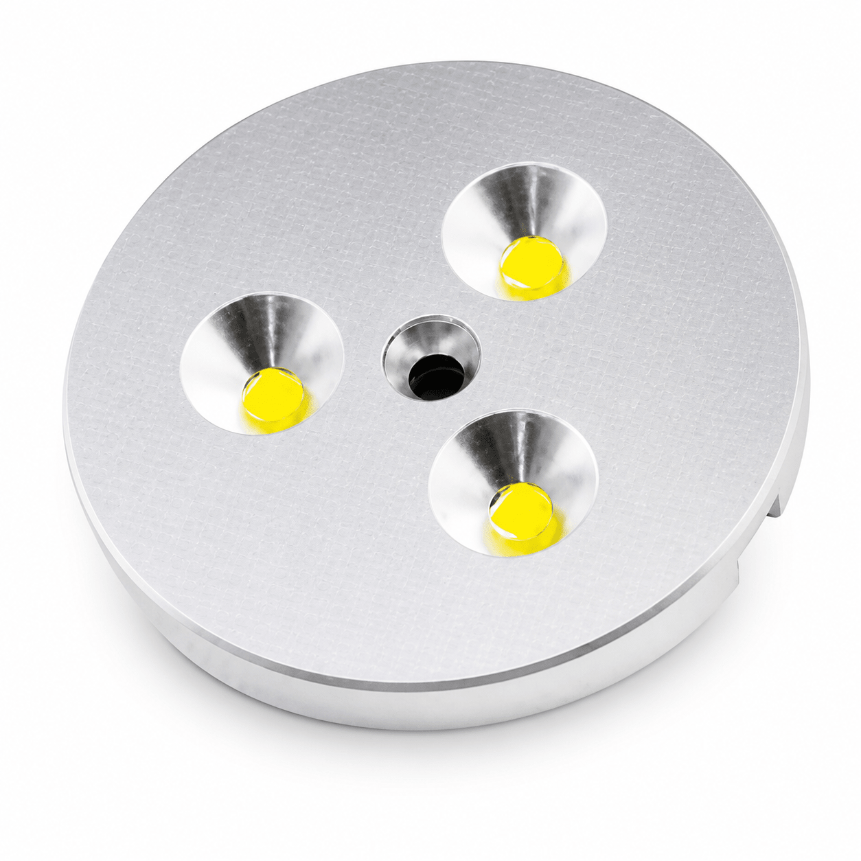 Three LED puck lights with yellow bulbs in a circular silver housing.