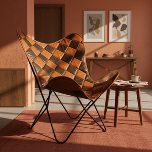 Leather Iron Butterfly Chair in a cozy room with a wooden table and decorative wall art.