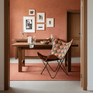 Leather Iron Butterfly Chair in a stylish dining area with a wooden table and decorative wall art.