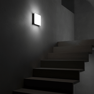 Modena CCT Outdoor LED Wall Light mounted on a textured wall, illuminating a staircase with soft light.