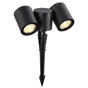Black dual‑head outdoor spike light with two adjustable heads on a pointed stake, illuminated, against green background.