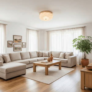 Round flush‑mount ceiling light with textured glass and gold finish above a beige sectional sofa in a bright living room.