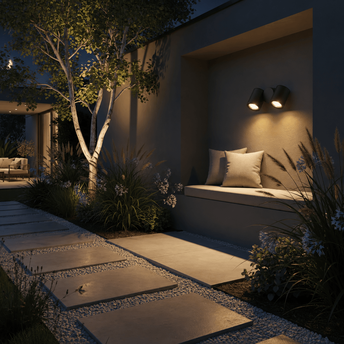 Double adjustable outdoor spot light mounted on wall illuminating garden bench and pathway