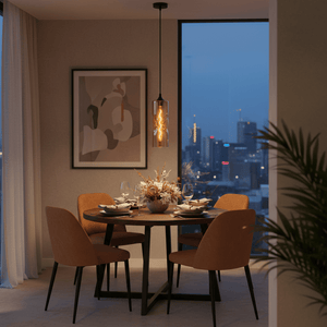 Amber twisted‑glass pendant light with filament hangs above a round dining table, city skyline visible through window.