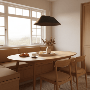 Dark grey felt pendant light hanging over a wooden dining table