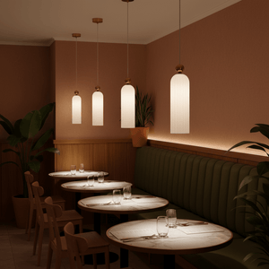 Four Antic White & Gold Pendant Lights hang above dining tables in a cozy restaurant setting.
