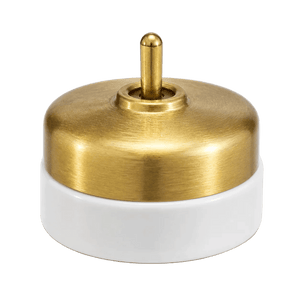 Brushed brass switch with a cylindrical white porcelain base, featuring a central toggle.