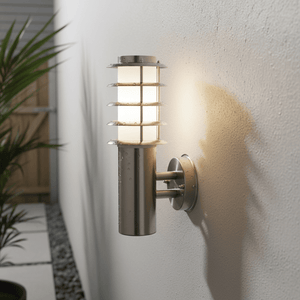 Stainless steel outdoor wall light mounted on a textured wall, casting a soft glow.