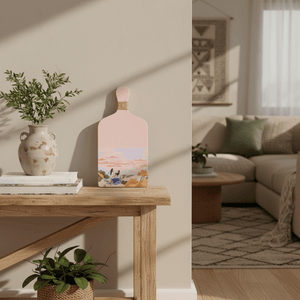 Light pink wooden figurine displayed on a wooden table with a vase and books, enhancing a cozy interior.
