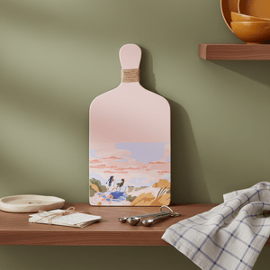pink ladies-themed decorative plaque styled on a table beside a cup and decor