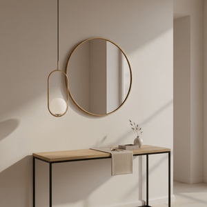 Luna Short G9 Pendant Light in gold hanging above a minimalist wooden console table with a round mirror.