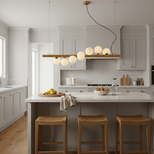 Spiral 7 Light Gold Pendant Light hanging above a modern kitchen island with opal glass spheres and warm gold finish.
