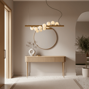 Spiral 7 Light Gold Pendant Light above a wooden console table with a round mirror and decorative vase.