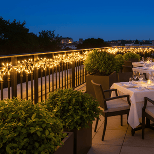 Warm white LED fairy lights illuminate a restaurant terrace, enhancing the evening ambiance with decorative glow.