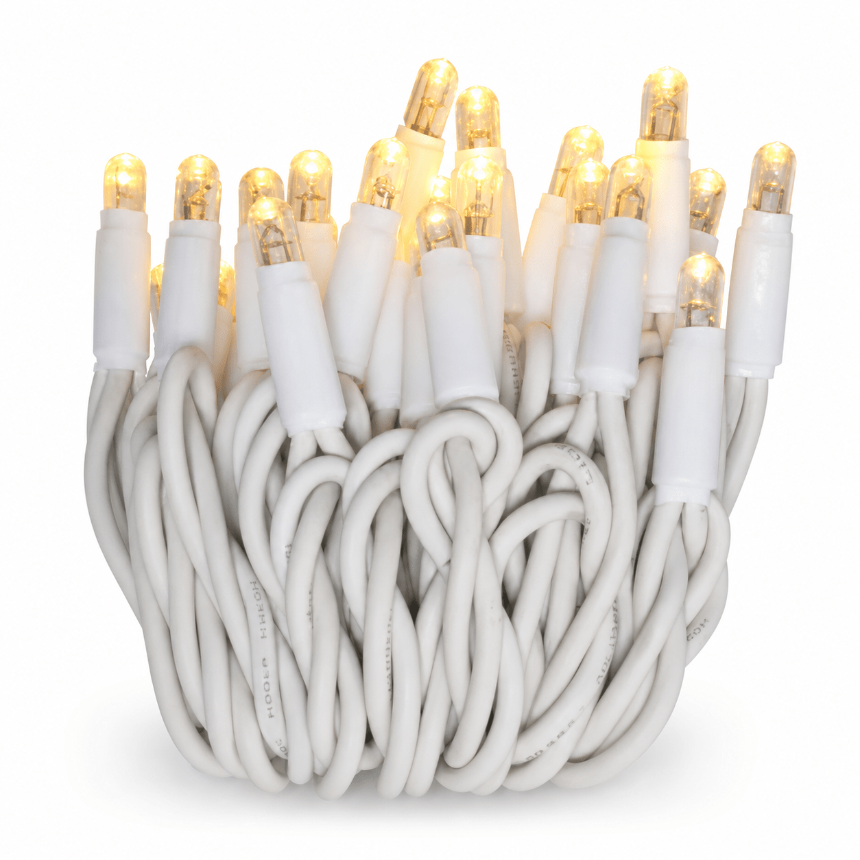 Coiled LED fairy lights with warm white bulbs on a white rubberized cable.